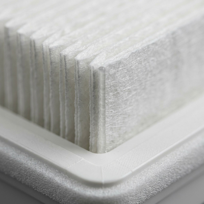 A macro photograph displaying the intricate pleats, fine fibers, and glue bead of the Sharp FZA28HFU HEPA filter.