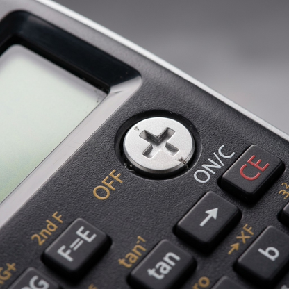 A focused macro detail shot of the silver power button and the textured plastic casing.