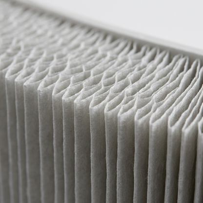 An extreme close-up photograph showcasing the intricate texture and precision pleats of the SHARP FZC100HFU HEPA air filter.