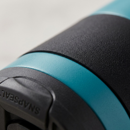 Extreme macro detail showing the precise texture of the SNAPSEAL lid and the matte body finish on the blue-teal Contigo mug.